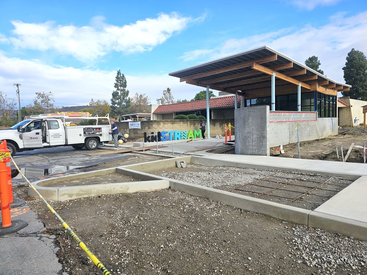 The kidSTREAM sign being installed in front of the nearly finished building.